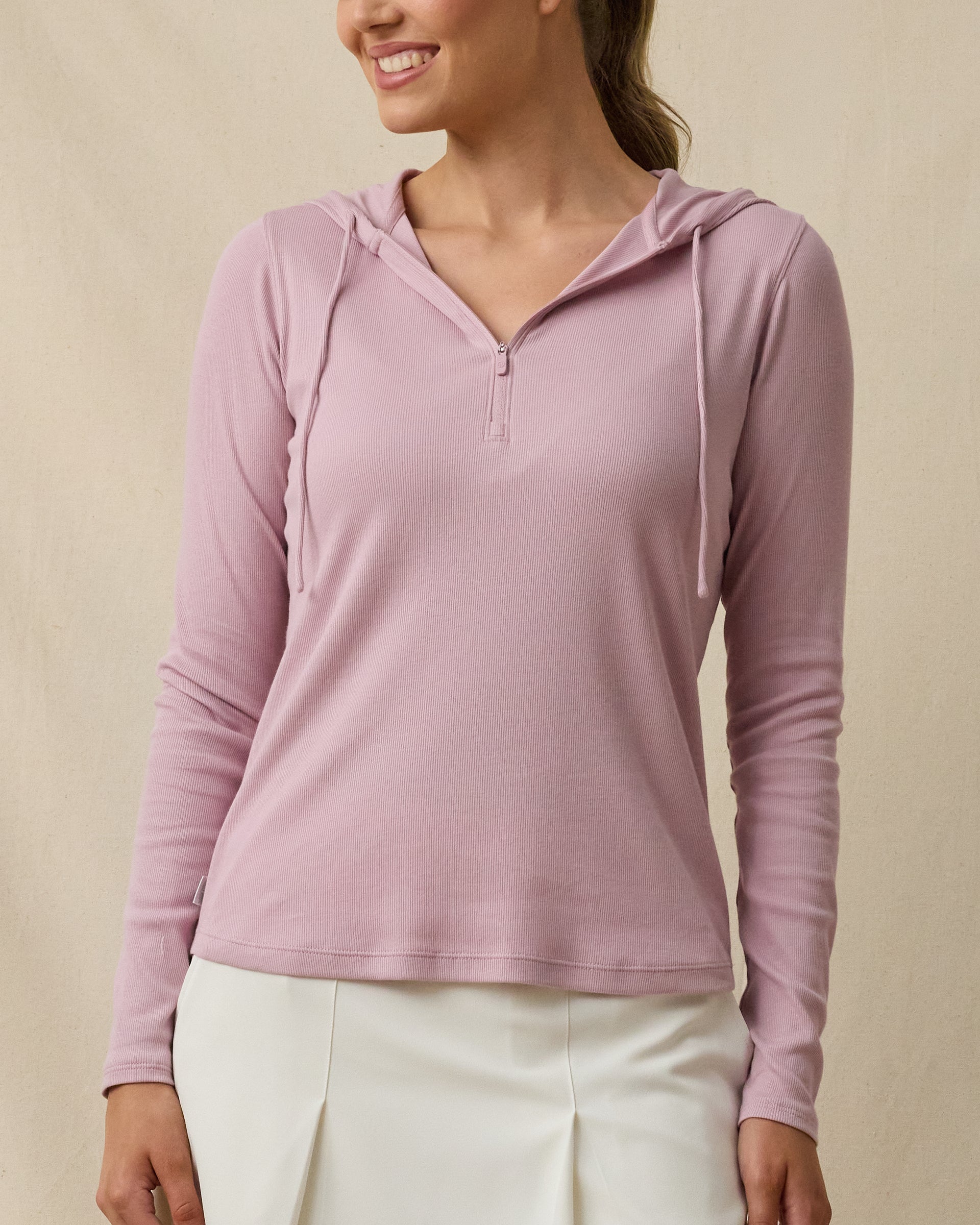 Woman wearing the Straight Down Thyme Quarter Zip Hoodie in Pink Dawn with a hood, quarter-zip neckline, and long sleeves
