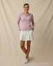 Woman wearing the Straight Down Thyme Quarter Zip Hoodie in Pink Dawn with a light golf skort