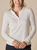 Women’s Cream long sleeve henley top with soft knit fabric, front view on model with button placket neckline, and ribbed cuffs.