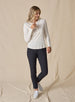 Women’s light grey long sleeve henley top with soft knit fabric, full body view on model with button placket neckline, and ribbed cuffs.