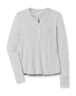 Women’s light grey long sleeve henley top with soft knit fabric, button placket neckline, and ribbed cuffs.