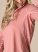 Women's Anza Quarter Zip in Cedar, detail model view highlighting the tonal contrast stitching along the raglan shoulder and side seams of the heathered rose pullover