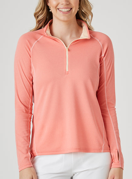 Women's Anza Quarter Zip in Grapefruit, front model close-up view featuring a heathered coral-orange long-sleeve pullover with a quarter-zip closure, peach interior collar lining, and tonal contrast stitching along the raglan seams