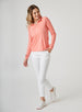 Women's Anza Quarter Zip in Grapefruit, full-length front model view featuring a heathered coral-orange long-sleeve pullover styled with white pants and white shoes
