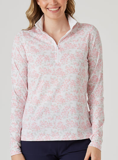 Alabama Quarter Zip in Flamingo, front model view featuring a white long-sleeve pullover with an allover pink floral and grey leaf print, quarter zip, and white mock neck collar, paired with navy pants