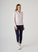 Alabama Quarter Zip in Flamingo, full-length front model view featuring a white long-sleeve pullover with an allover pink floral and grey leaf print, quarter zip, and white mock neck collar, paired with navy cropped pants and white shoes