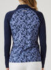 Mabel Quarter Zip in New Indigo, back model view featuring a long-sleeve pullover with an allover navy and blue abstract floral print body, solid navy raglan sleeves, and Straight Down logo at the upper back neckline, paired with white pants