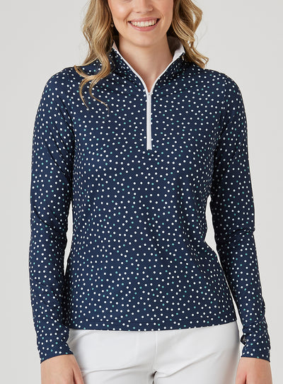 Women's Galaxy Quarter Zip in New Indigo, front model close-up view featuring a navy long-sleeve pullover with an all-over scattered white and teal polka dot print and a quarter-zip closure with a contrast white zipper pull