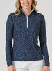 Women's Galaxy Quarter Zip in New Indigo, front model close-up view featuring a navy long-sleeve pullover with an all-over scattered white and teal polka dot print and a quarter-zip closure with a contrast white zipper pull
