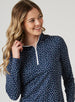 Women's Galaxy Quarter Zip in New Indigo, front model close-up view highlighting the quarter-zip closure, contrast white zipper pull, and white interior collar lining against the navy scattered white and teal polka dot print fabric