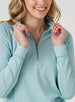 Witney Quarter Zip in Sea Green, close up detail view on model showing the green lined collar, quarter zip closure, contrast stitching, and light aqua and white houndstooth print