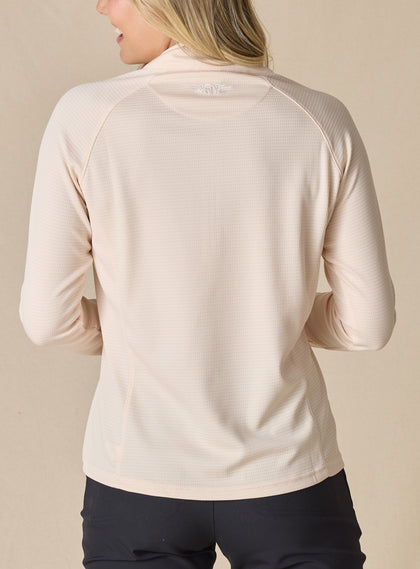 Women's Ellen Quarter Zip in Peche, back view on model featuring a soft peach textured performance fabric with raglan sleeve construction and tonal Straight Down logo at the upper back, paired with black pants
