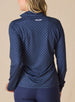 Dottie Quarter Zip in Cedar, back model view featuring a navy long-sleeve pullover with an allover pink polka dot print and Straight Down logo at the upper back neckline, paired with navy pants