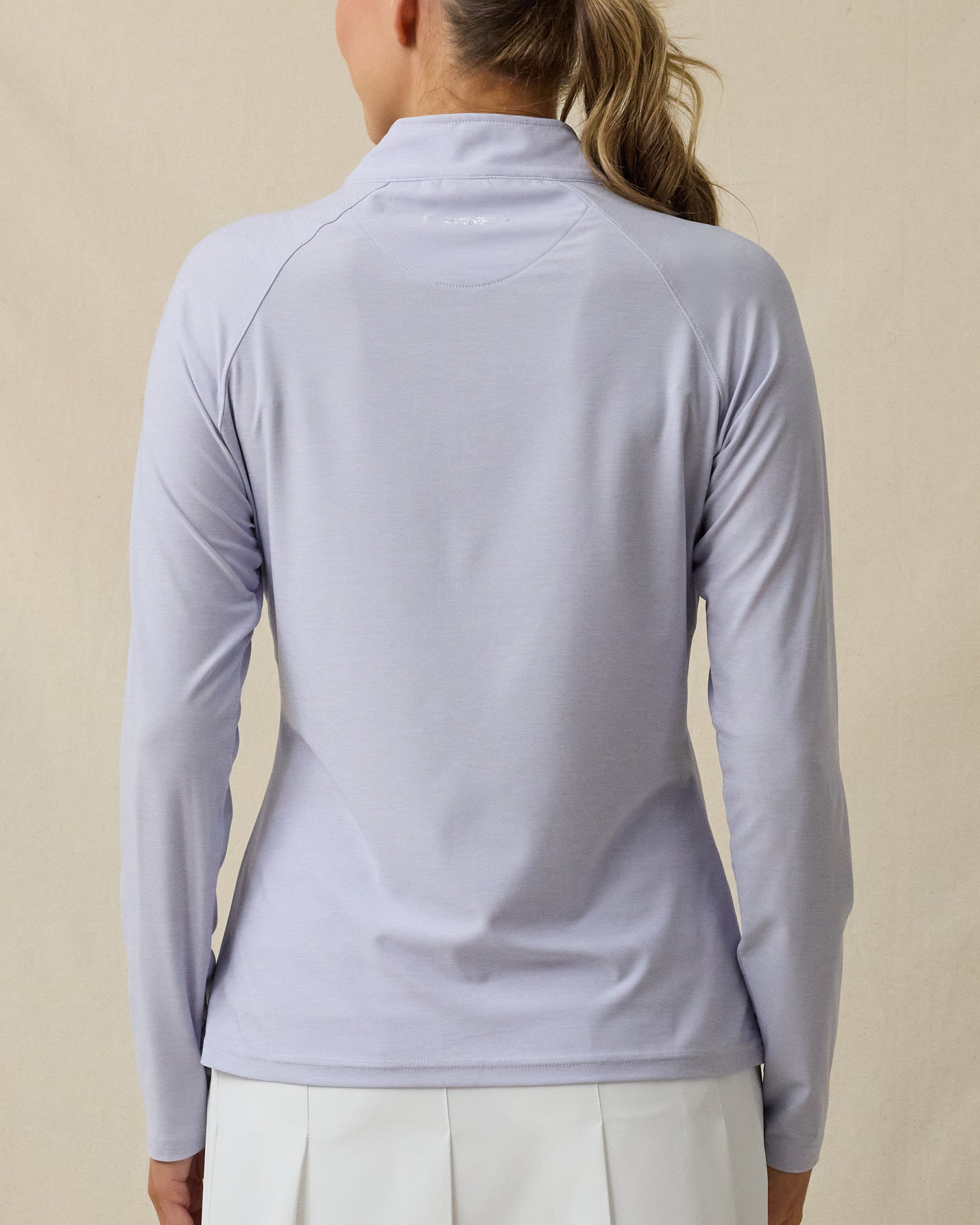 Back view of the Clara Quarter Zip in Cosmic Blue, featuring a subtle logo detail at the back neck