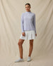 Model wearing the Clara Quarter Zip in Cosmic Blue fully zipped paired with light skort