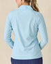 Clara Quarter Zip in Gemstone, back view featuring a solid light blue long sleeve pullover with Straight Down embroidered logo at the upper back, paired with navy pants