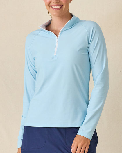 Clara Quarter Zip in Gemstone, front view featuring a solid light blue long sleeve pullover with white quarter zip and white contrast collar lining, paired with navy pants