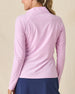 Clara Quarter Zip in Pink Floyd, back view on model in solid light pink with Straight Down logo embroidered at center back, paired with a navy skort