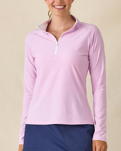 Clara Quarter Zip in Pink Floyd, front view on model in solid light pink with a white quarter zip and white collar interior, paired with a navy skort