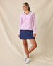 Clara Quarter Zip in Pink Floyd, full-length front angle view on model in solid light pink with a white quarter zip and white collar interior, paired with a navy skort and white golf shoes