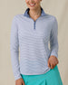 Model wearing the Kiri Stripe Quarter Zip in Tidal Blue with aqua golf skort, front view