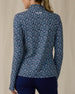 Women's Flores Quarter Zip in New Indigo, back on-model view featuring a navy long sleeve quarter zip pullover with an allover small floral print in white and mint green tones, mock neck collar, and Straight Down logo embroidered at the upper back, paired with navy pants