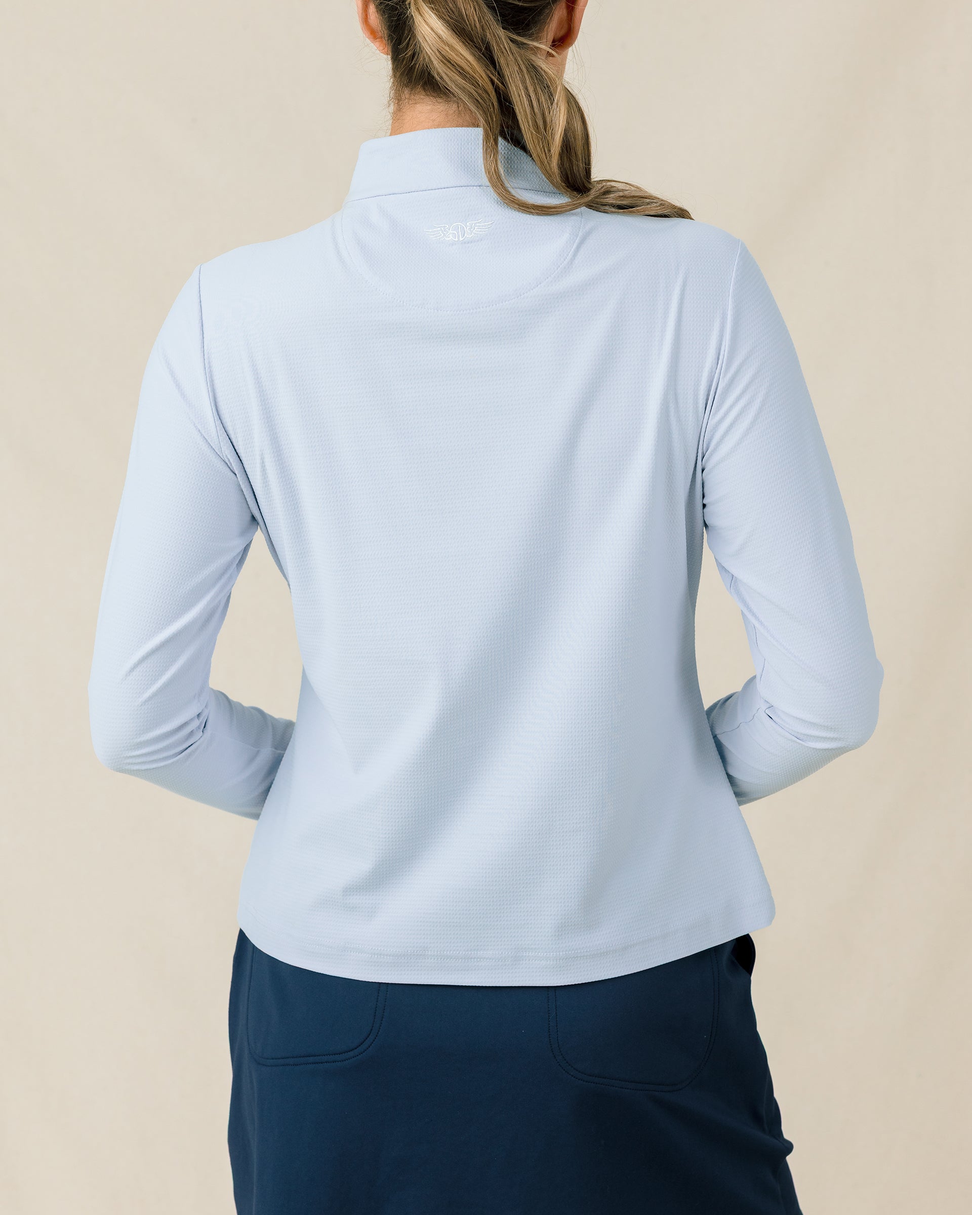 Mylite Quarter Zip in Lake blue with textured stretch fabric, back model view