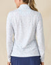 Mariette Quarter Zip in Gemstone, back view featuring a white base with light blue and mauve floral vine allover print pattern with Straight Down embroidered logo at the upper back, paired with navy pants