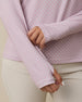 Close-up of the Empress Quarter Zip in Pink Dawn showing the geometric floral print and thumbhole cuff detail