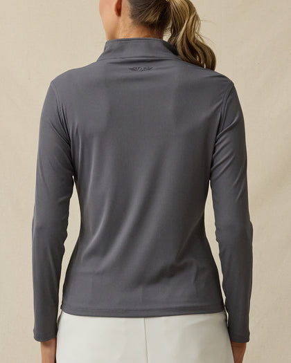 Back view of a woman wearing the Skyler Quarter Zip in Nightshade, showing the ribbed texture and tonal embroidered logo below the back collar.