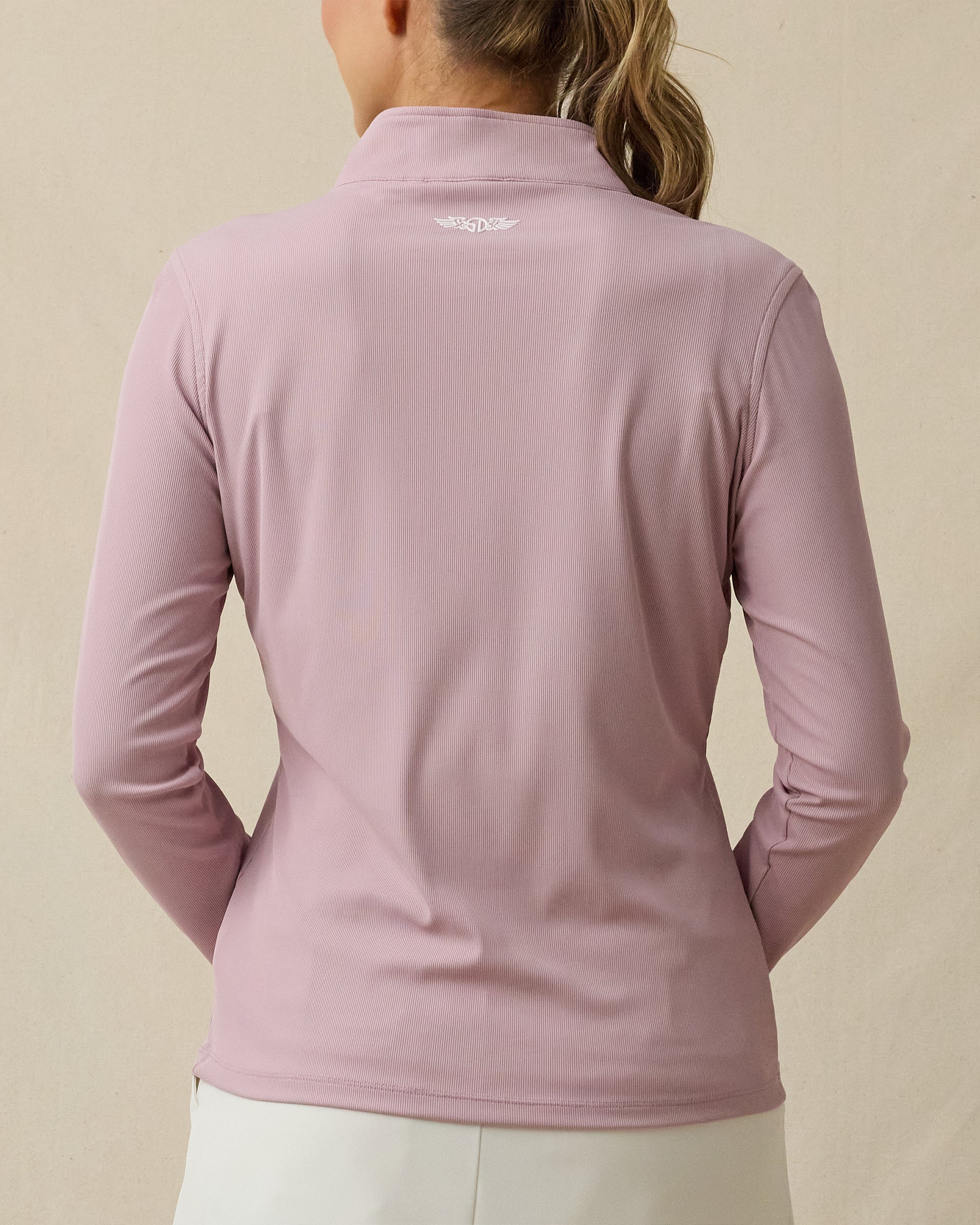 Back view of the Skyler Quarter Zip in Pink Dawn, featuring logo detail at the back collar