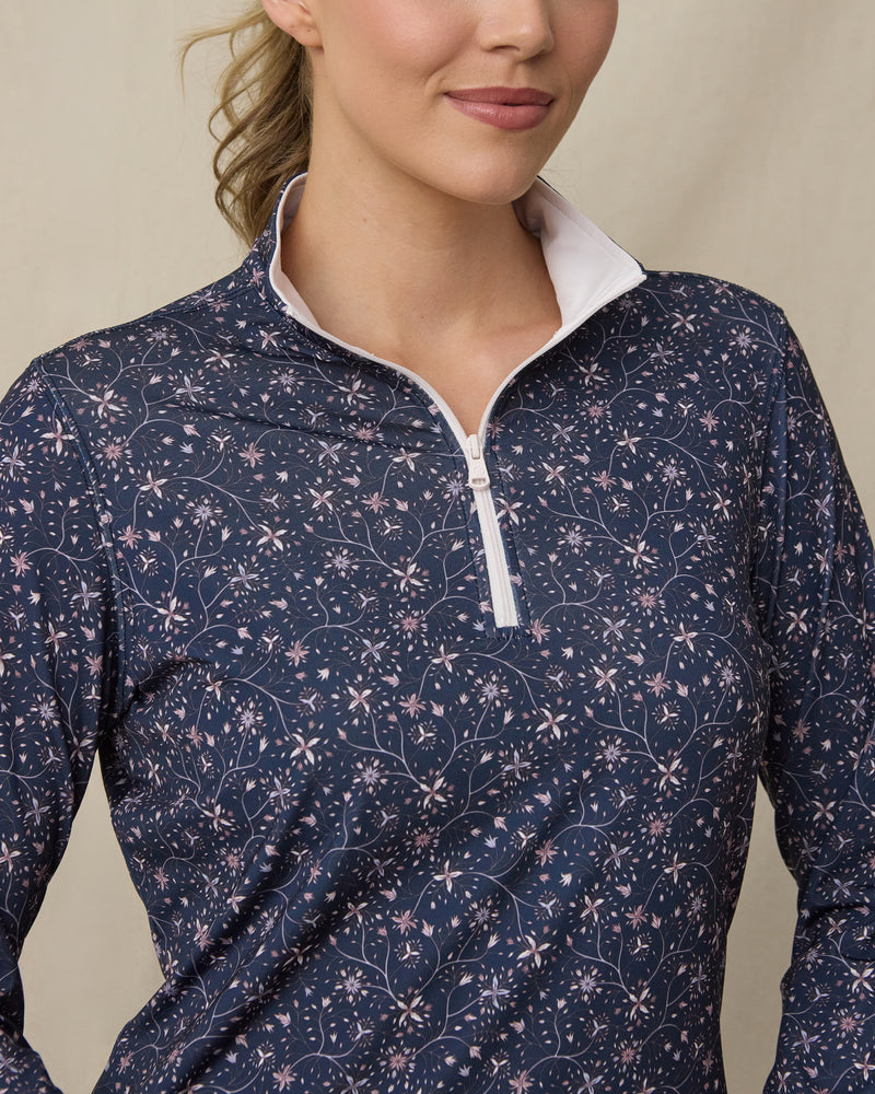 Close-up of the Erika Quarter Zip in New Indigo highlighting the floral vine print, quarter-zip neckline, and contrast white collar interior