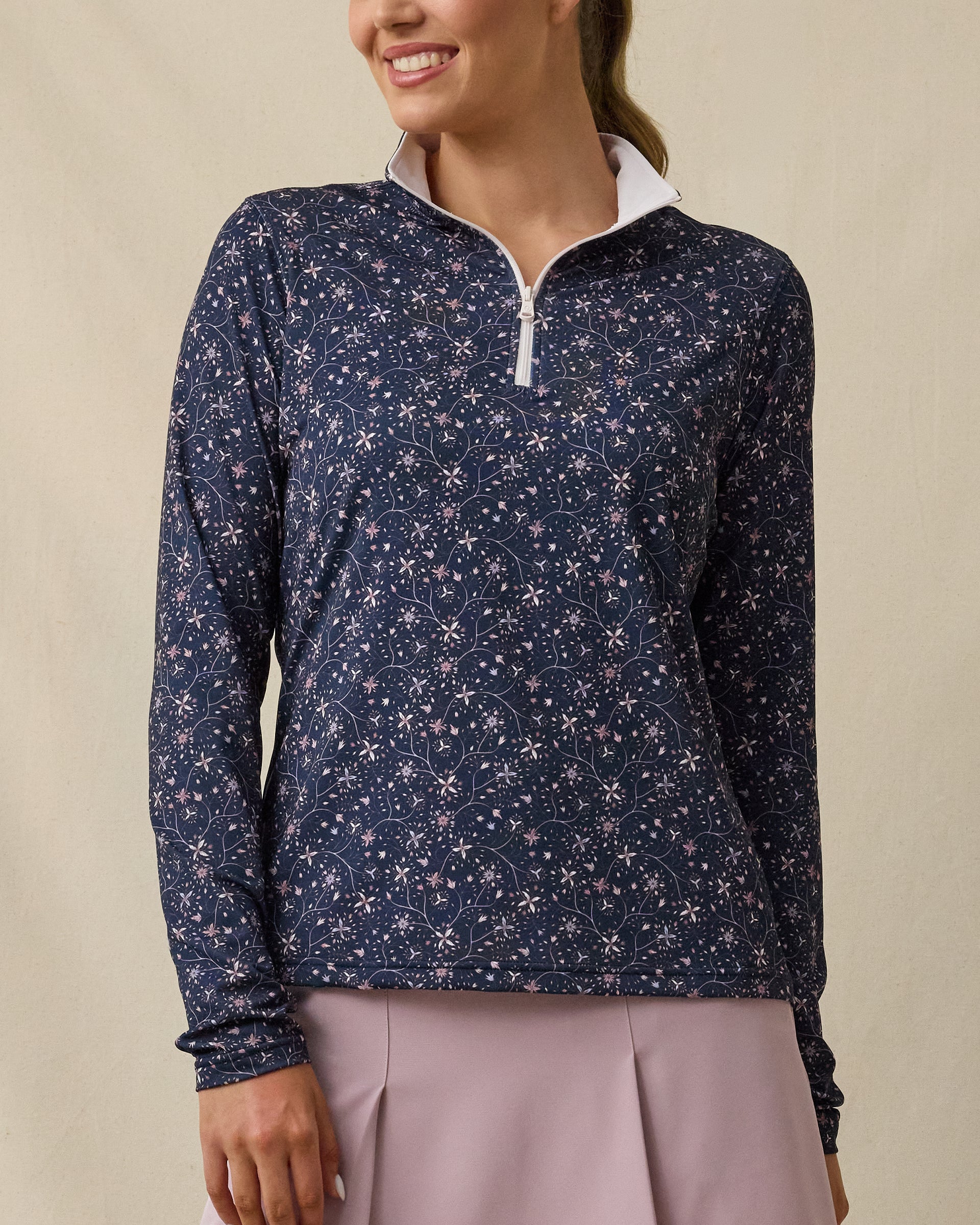 Model wearing the Erika Quarter Zip in New Indigo with a delicate floral vine print, front view