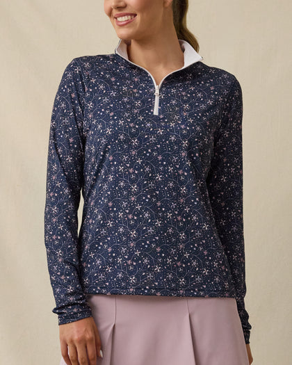 Model wearing the Erika Quarter Zip in New Indigo with a delicate floral vine print, front view