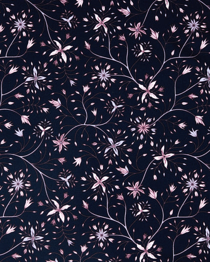 A close-up of a repeating floral pattern on a dark navy background, featuring light pink and white blossoms with thin brown stems and leaves.