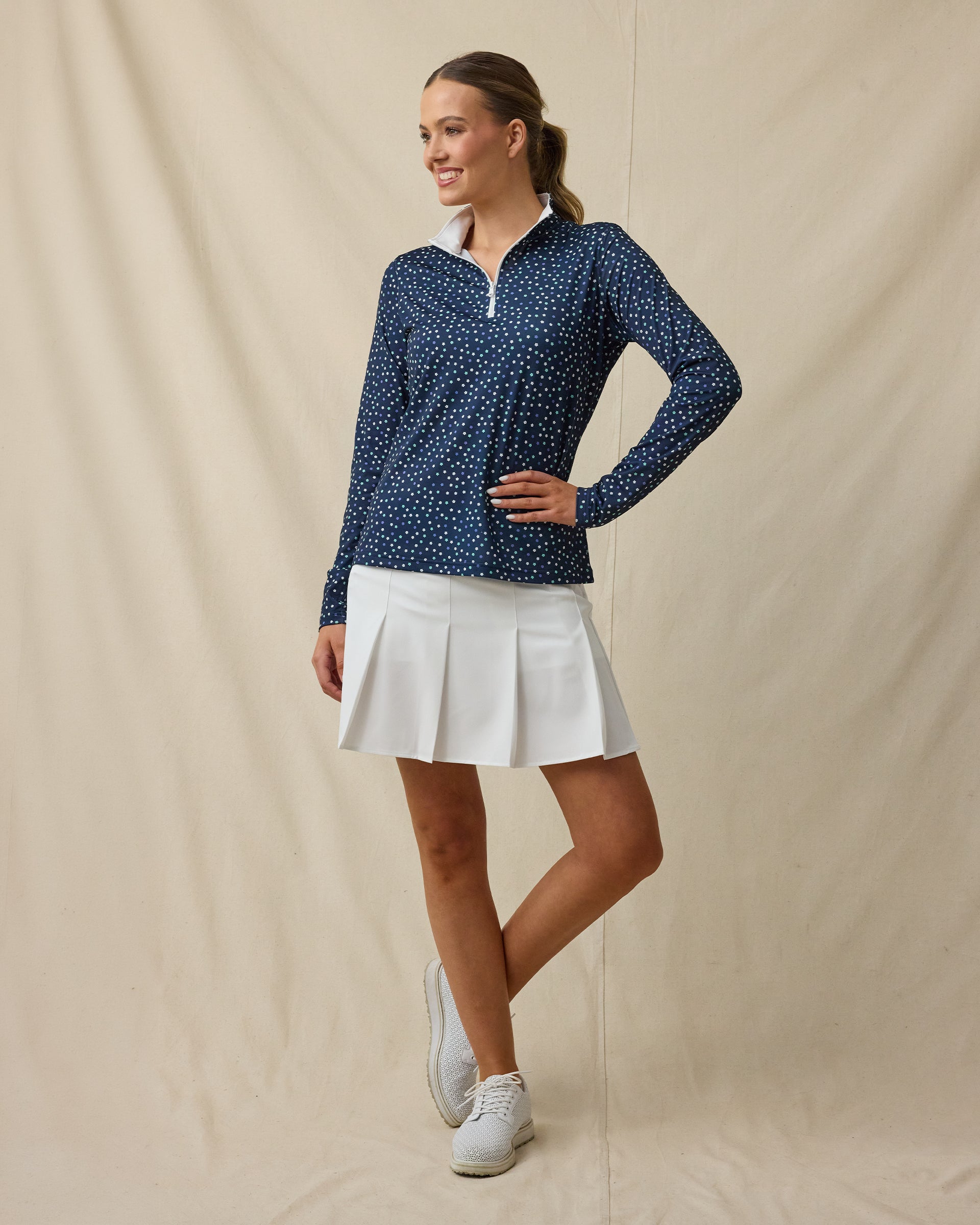 Sprinkles Quarter Zip in New Indigo, full outfit model view styled with white golf skort, collar open