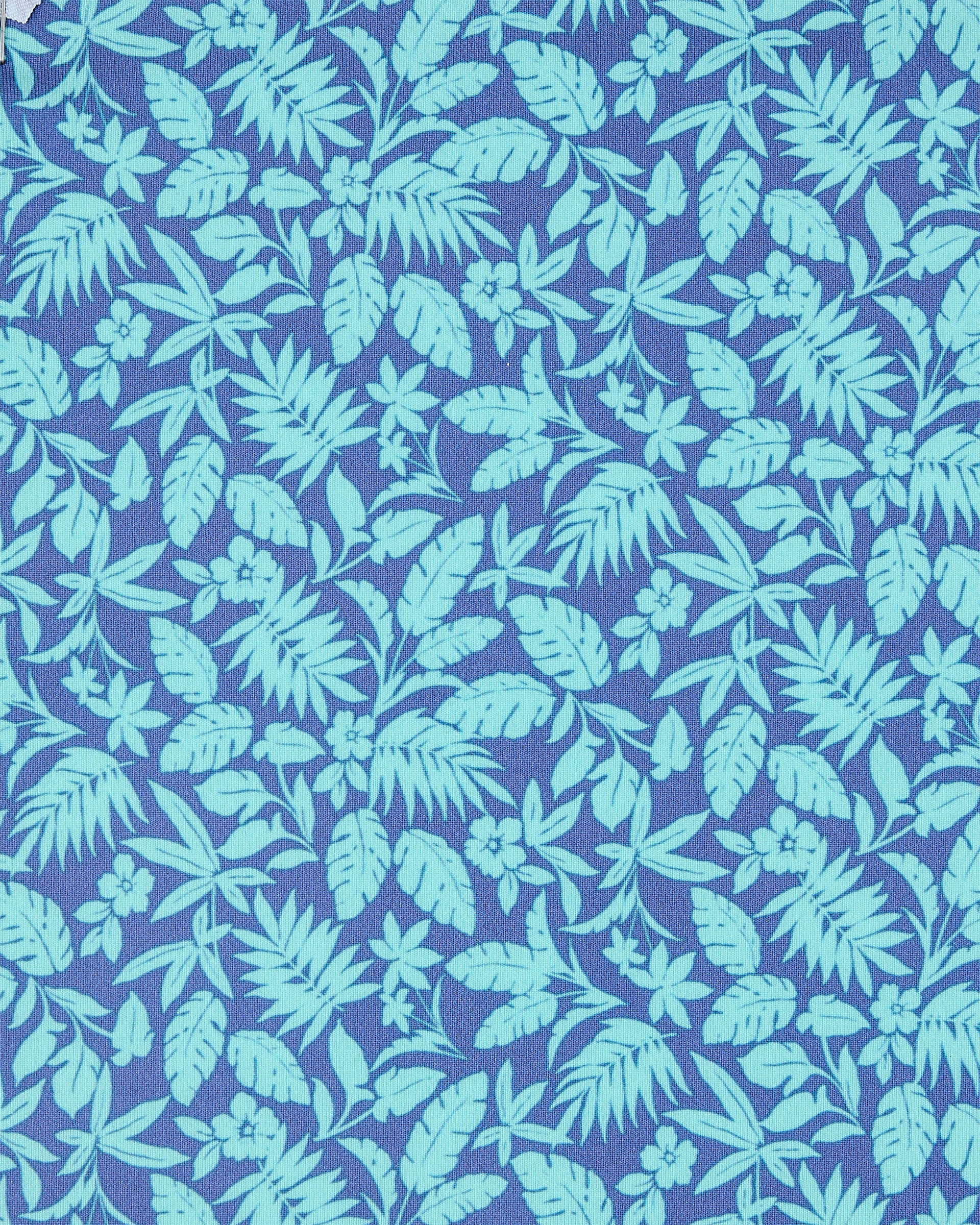A close-up of a tropical leaf and floral pattern in light aqua green on a medium periwinkle blue background.