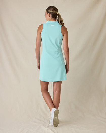 Women's Greta Dress in Green Stone, full-length back on-model view featuring a solid mint green sleeveless polo dress with a spread collar and Straight Down logo embroidered at the upper back, paired with white shoes