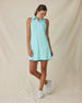 Women's Greta Dress in Green Stone, full-length front on-model view with a relaxed stance featuring a solid mint green sleeveless polo dress with a spread collar, white quarter zip, and side zip pockets, paired with white shoes