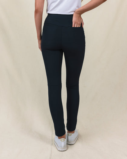 Lexi Pant in Black, back view on model featuring solid black fabric with clean waistband and back pocket detail styled with a white top and white shoes