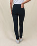 Lexi Pant in Black, back view on model featuring solid black fabric with clean waistband and back pocket detail styled with a white top and white shoes