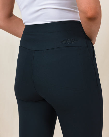 Lexi Pant in Black, close up detail view on model showing the wide waistband, tonal Straight Down logo embroidery, and back pocket detail in solid black fabric