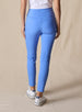 Lexi Pant in Maison, back view on model featuring solid medium blue fabric with wide waistband, back pockets, and tonal Straight Down logo embroidery styled with a white top and white shoes