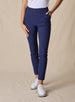 Lexi Pant in New Indigo, front view on model featuring solid navy fabric with side pockets and clean waistband styled with a white top and white shoes