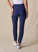 Lexi Pant in New Indigo, back view on model featuring solid navy fabric with wide waistband, back pockets, and tonal Straight Down logo embroidery styled with a white top and white shoes