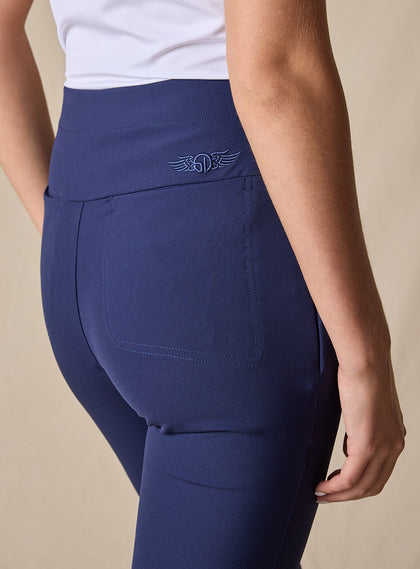 Lexi Pant in New Indigo, close up detail view on model showing the wide waistband, tonal Straight Down logo embroidery, and back pocket detail in solid navy fabric