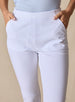 Lexi Pant in White, close up detail view on model showing the clean waistband, center front seam, and side pocket openings in solid white fabric