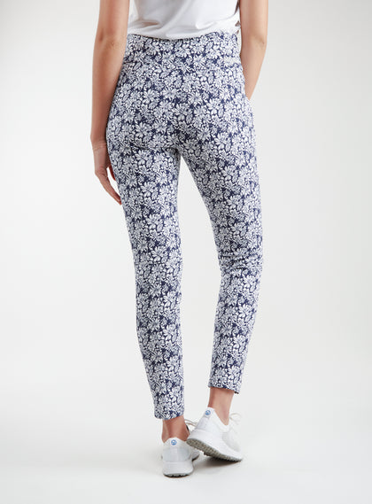 Lexi Pant in White Indigo, back view on model featuring a navy and white all-over daisy floral print styled with a white top and white shoes