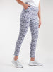 Lexi Pant in White Indigo, side view on model featuring a navy and white all-over daisy floral print with hand in side pocket styled with white shoes