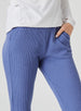 Women's Mavis Jogger in Blueberry, close-up model view featuring a medium blue waffle-knit jogger with elasticated waistband, front seam detail, side pocket, and tonal Straight Down logo patch